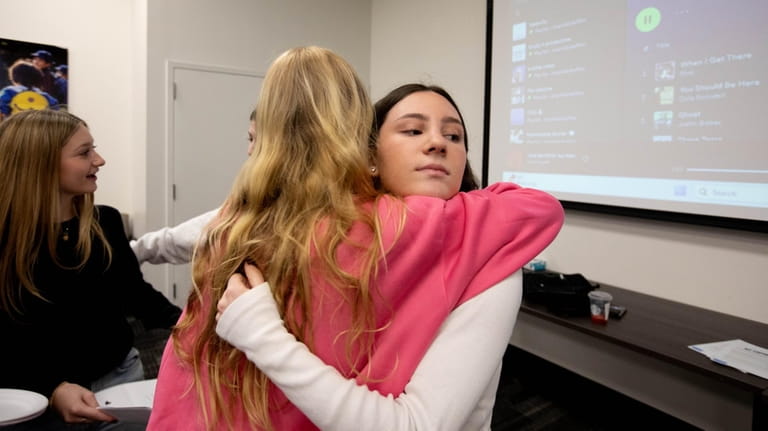 Sydney Hassenbein hugs a participant after a recent session.