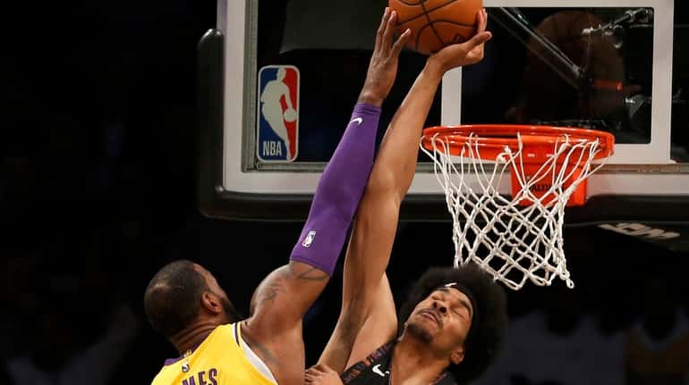 The Nets' Jarrett Allen blocks a shot from the Lakers'...