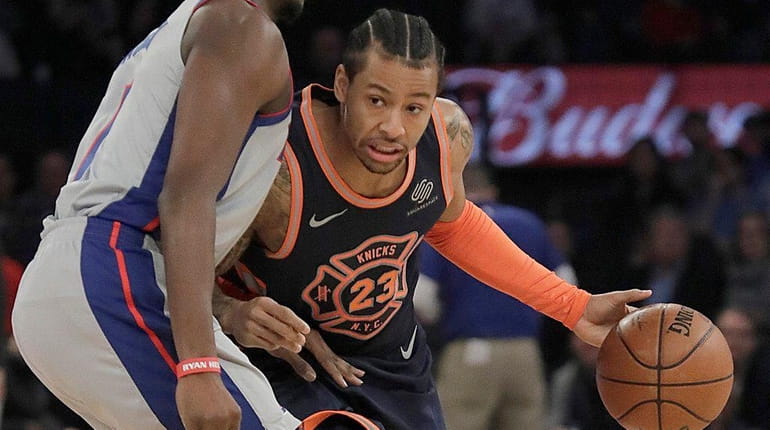 Knicks guard Trey Burke drives against Pistons center Andre Drummond...