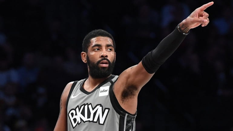 Nets guard Kyrie Irving gestures during the first half against the...