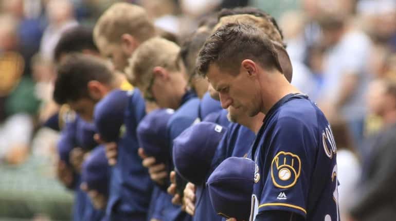 Members of the Milwaukee Brewers take a moment of silence...