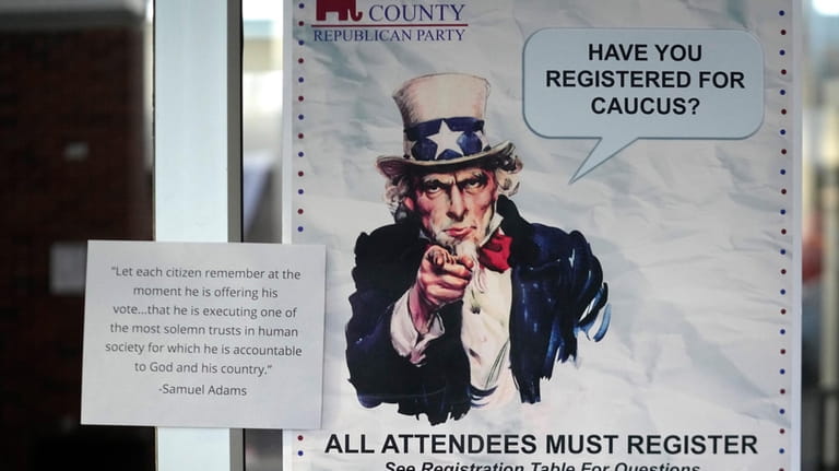 A HAVE YOU REGISTERED FOR CAUCUS sign hangs on a...