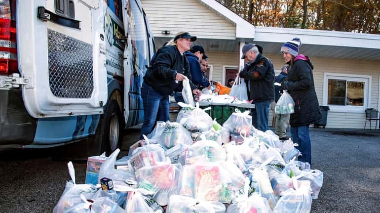 Island Harvest and members of the Suffolk County PBA distribute turkeys to veterans...