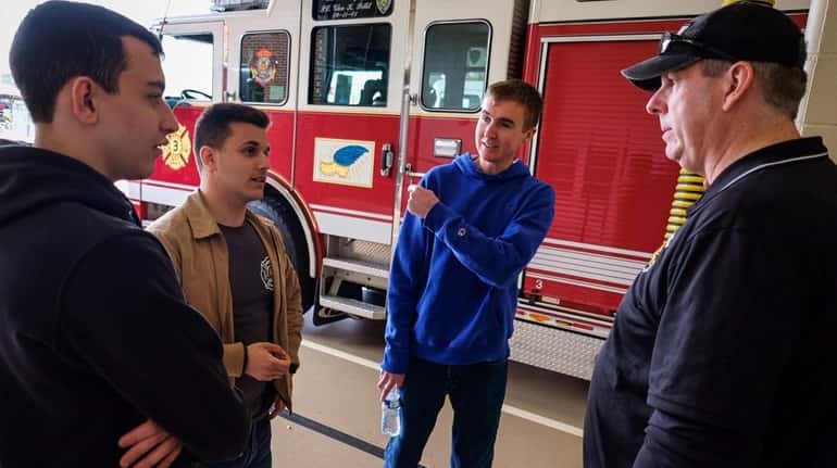 West Sayville Fire Department 1st Assistant Chief Jeff Houghtalen, right, with...