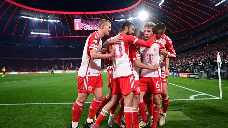 Bayern's Joshua Kimmich, centre right, celebrates with teammates after scoring...