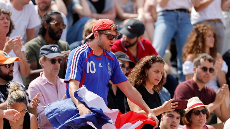 A fan encourages France's Hugo Gaston during the first round...