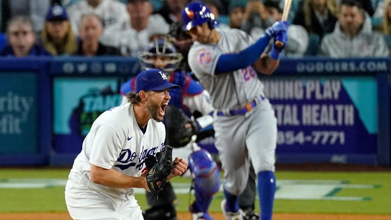 Los Angeles Dodgers' Clayton Kershaw, left, celebrates as he strikes...