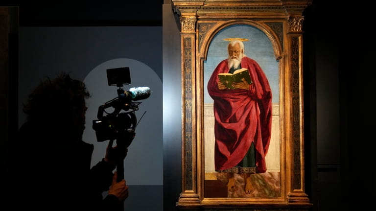 A cameraman films the Italian artist Piero della Francesca's St....
