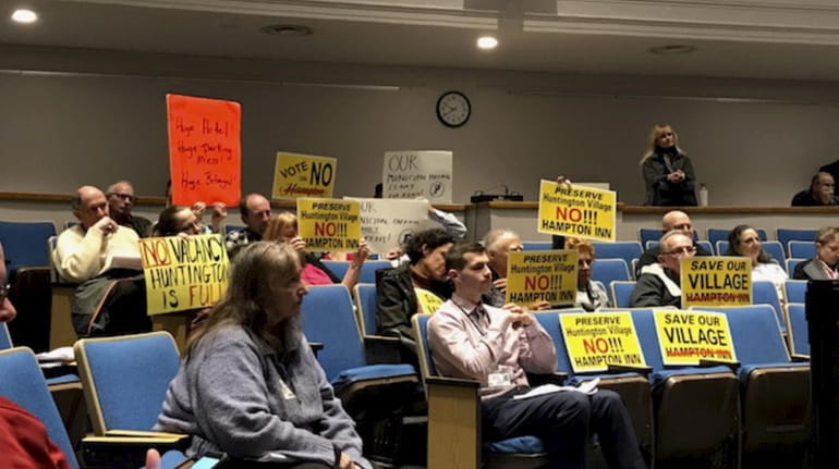 Opponents of a Hampton Inn attend the Huntington Town Board meeting...