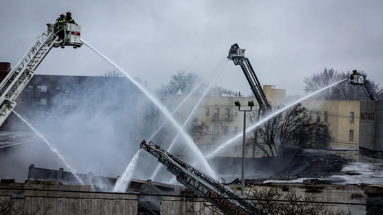 Firefighters battle a blaze Saturday in a building at 30...