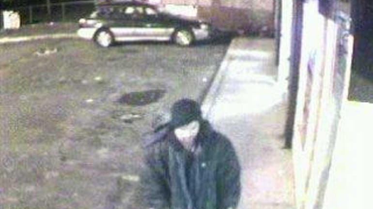 This is a surveillance photo of the suspect wanted for...