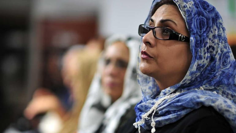 Nazli Chadhry of Commack listens to Dr. Azizah al-Hibri, founder...