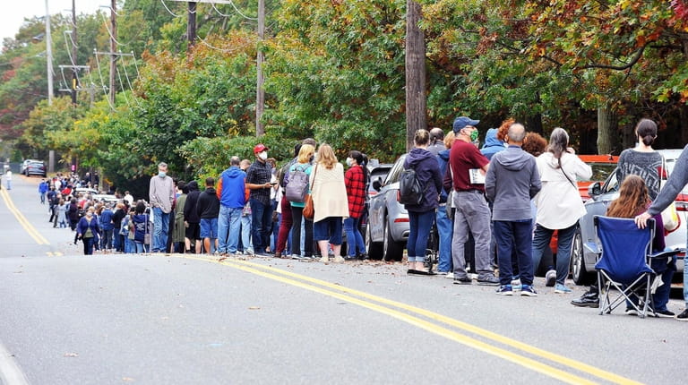 In Nesconset, crowds wait along Browns Road to enter a polling...