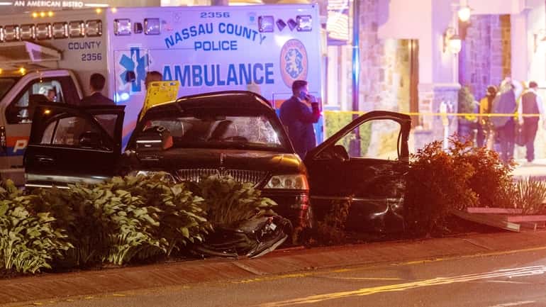 Nassau County police investigate the scene of the late-night crash Saturday...