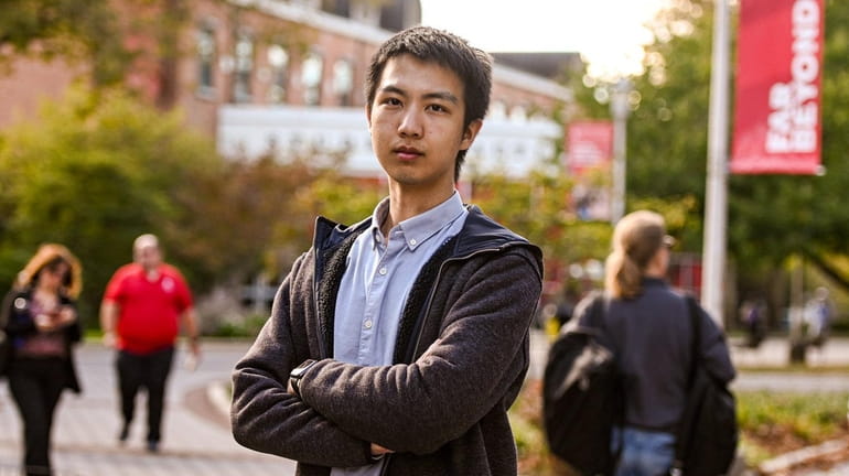 Stony Brook University physics student Jiazu Zhang, from China, stands...