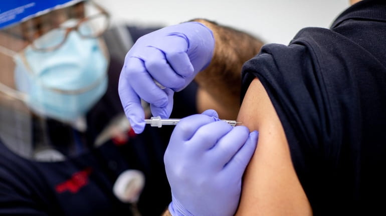 A COVID-19 vaccination Dec. 15 at Stony Brook University Hospital.