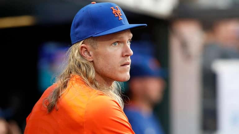 Noah Syndergaard of the Mets looks on from the dugout...