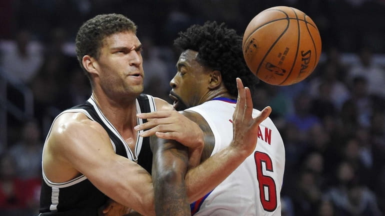 Brooklyn Nets center Brook Lopez, left, tangles with Los Angeles...