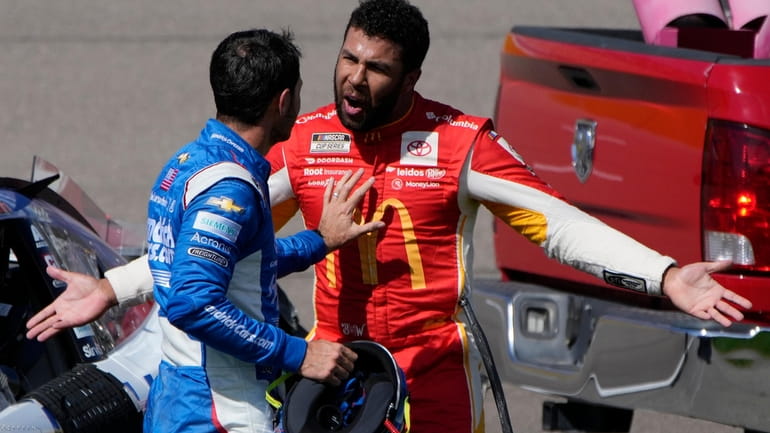 Bubba Wallace, right, argues with Kyle Larson after the two...