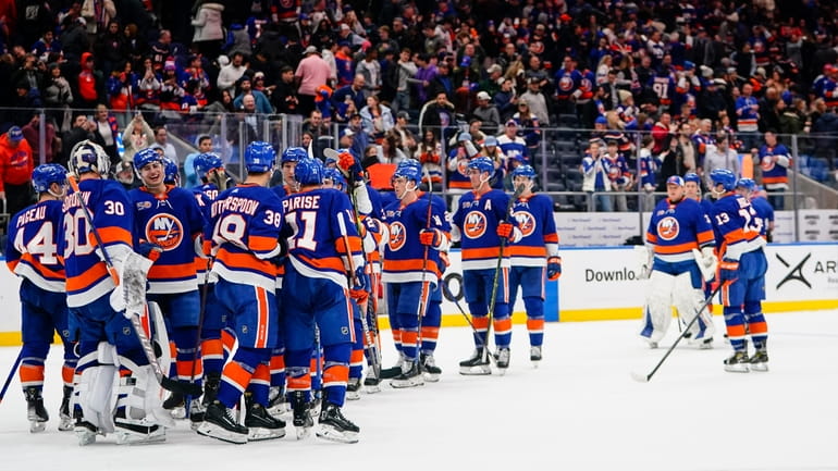 Islanders goaltender Ilya Sorokin (30) celebrates with teammates after an...
