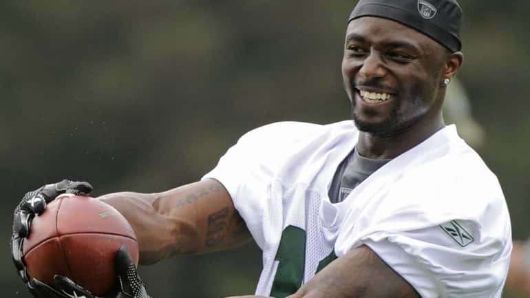 Jets wide receiver Santonio Holmes catches a pass during a...