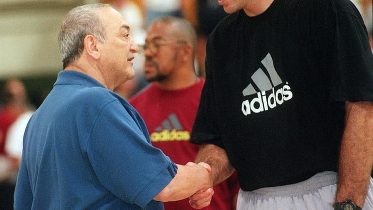 Adidas ABCD camp founder Sonny Vaccaro, left, greets an attendee...