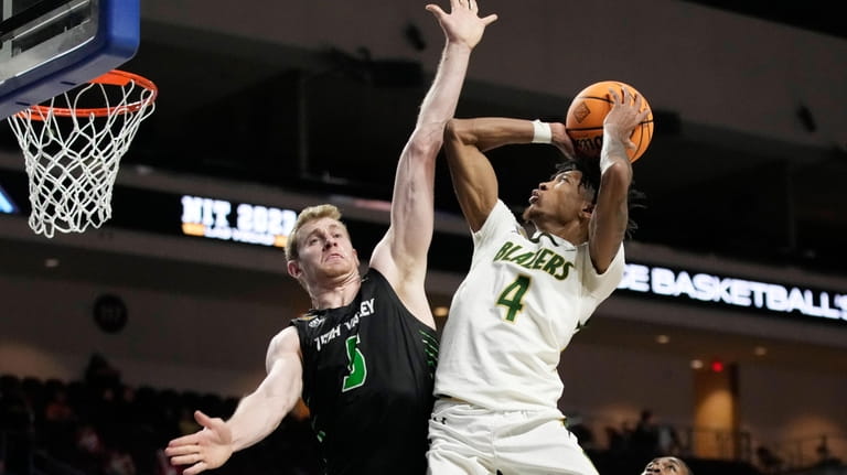 UAB's Eric Gaines (4) shoots over Utah Valley's Tim Fuller...