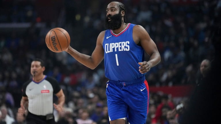 Los Angeles Clippers guard James Harden brings the ball up...