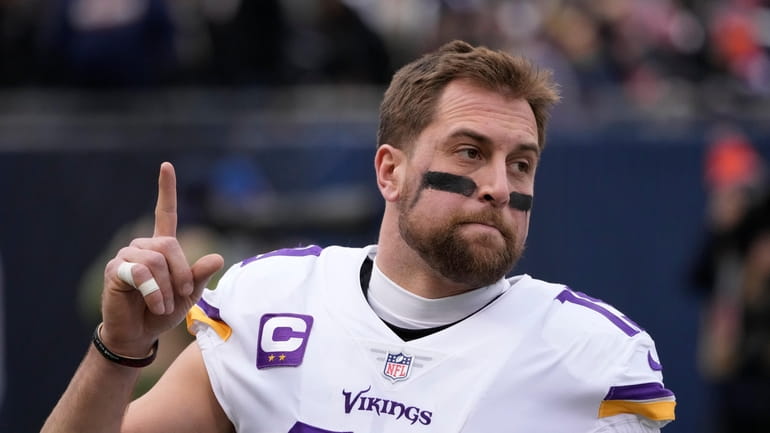FILE - Minnesota Vikings' Adam Thielen points skyward before an...