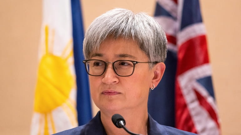 Australian Foreign Minister Penny Wong listens beside Philippine Foreign Affairs...