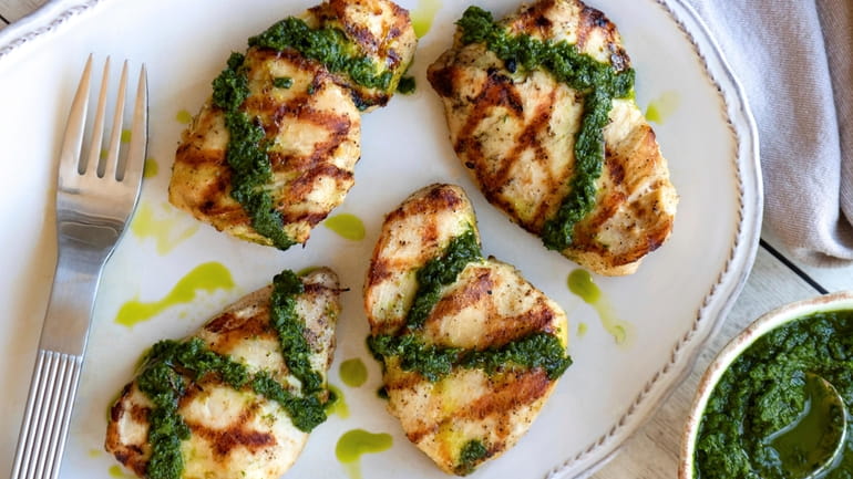Simply seasoned chicken breasts are grilled and topped with blender-made...