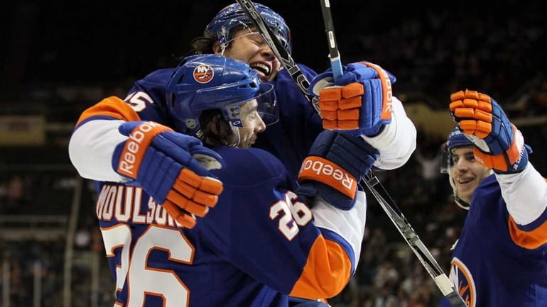 Matt Moulson of the New York Islanders celebrates his first...
