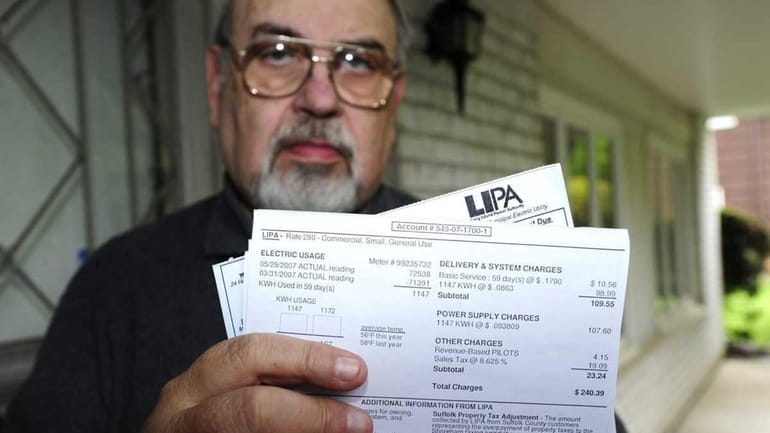 Hal Bock with some of his LIPA bills, which indicate...