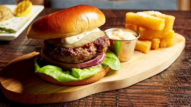 The provolone-draped picanha burger is available on the bar menu at Fogo...