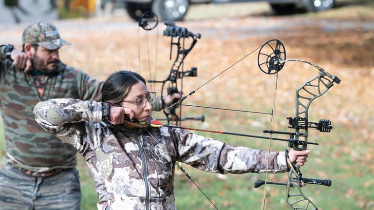 Tracey Campos target practicing before going out on a hunt.