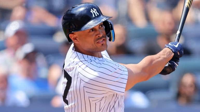 Giancarlo Stanton of the Yankees hits a three-run home run to...