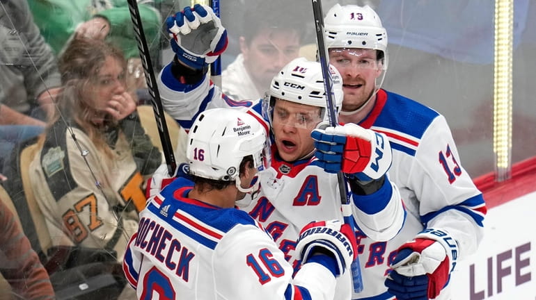 The Rangers' Artemi Panarin celebrates his goal with Vincent Trocheck and...