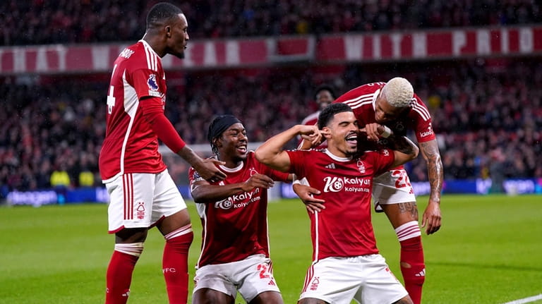 Nottingham Forest's Morgan Gibbs-White, second from right, celebrates with teammates...