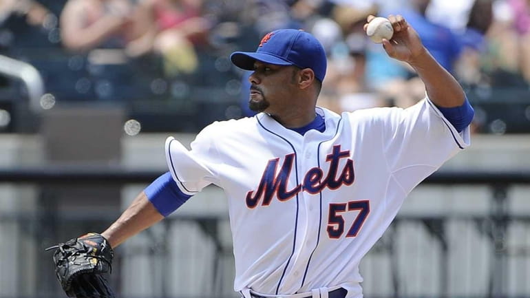 Mets pitcher Johan Santana delivers in the second inning against...