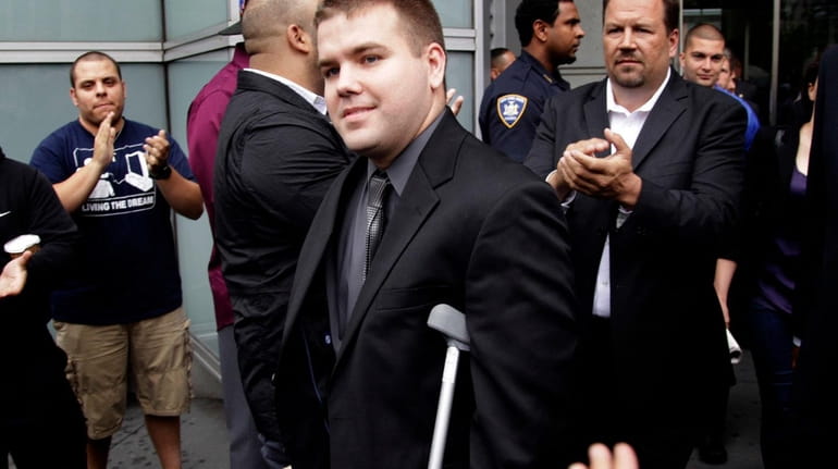 NYPD Officer Richard Haste leaves court in 2012 to applause...
