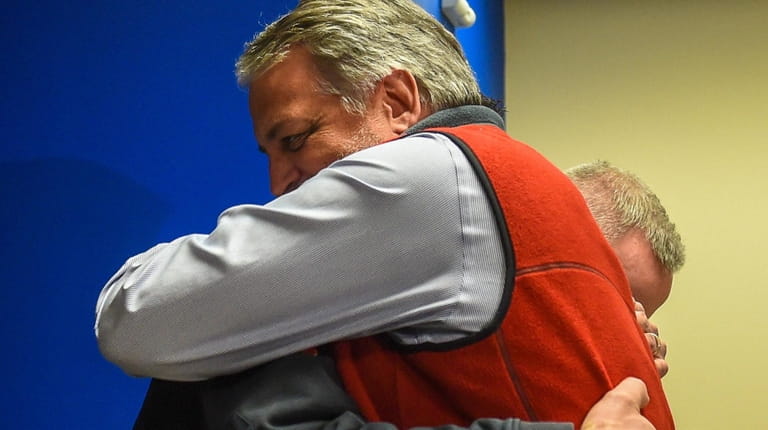 Greg Antolini hugs Marine Bureau Lt. Edward Mulroy at police headquarters on...
