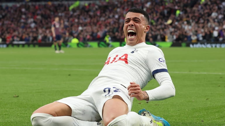 Tottenham's Pedro Porro celebrates after scoring his side third goal...