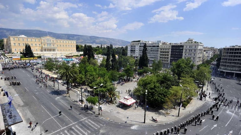 Riot police surround Syntagma square during a 48-hour general strike...