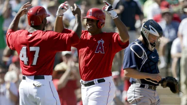 Los Angeles Angels outfielder Vernon Wells, center, celebrates his two-run...