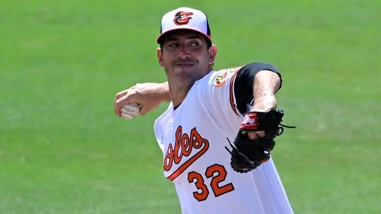 Matt Harvey of the Orioles throws a pitch during the...