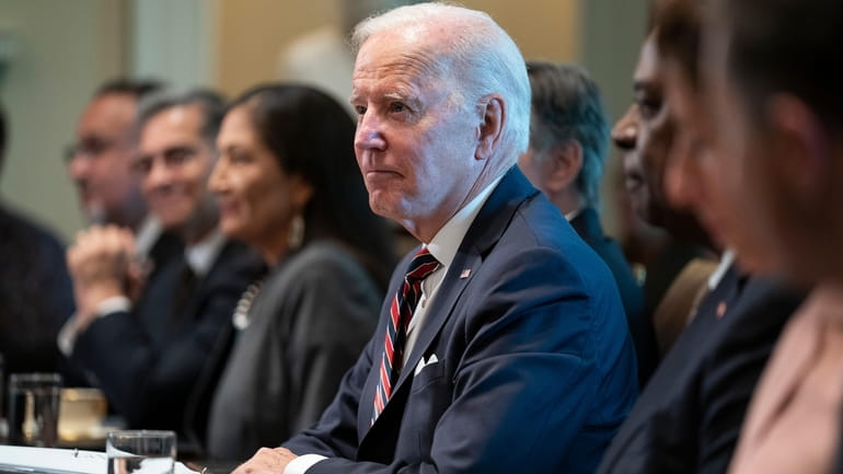 President Joe Biden listens to questions from reporters during a...