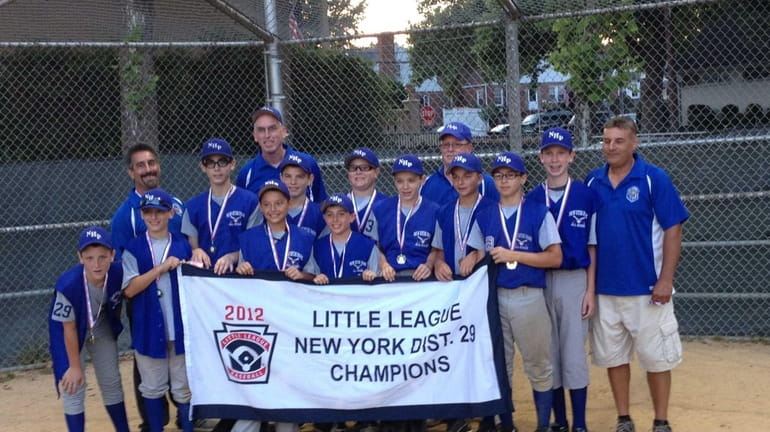 New Hyde Park 12-year-olds hold their championship banner after winning...