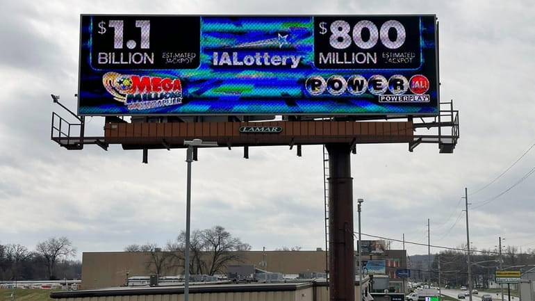 An electronic billboard advertises the Mega Millions and Powerball jackpots,...
