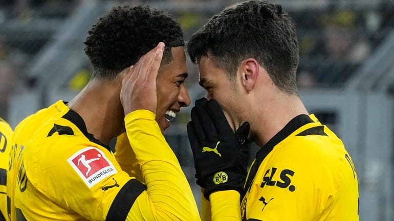 Dortmund's Jude Bellingham, left, celebrates with Dortmund's Giovanni Reyna, right,...