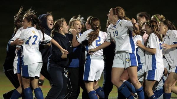 The West Islip girls soccer team celebrates their miracle come-from-behind...